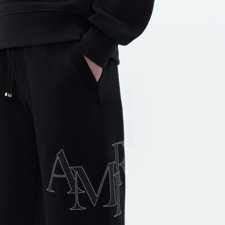 AMIRI Staggered Logo Track Pants | Black